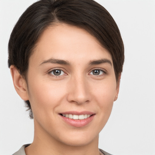 Joyful white young-adult female with short  brown hair and brown eyes