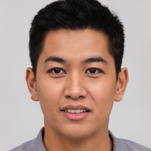 Joyful asian young-adult male with short  black hair and brown eyes