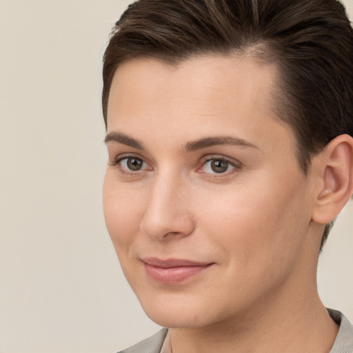 Joyful white young-adult female with short  brown hair and brown eyes