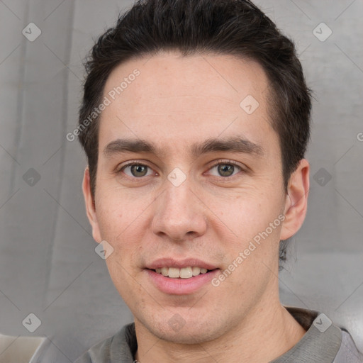 Joyful white adult male with short  brown hair and brown eyes