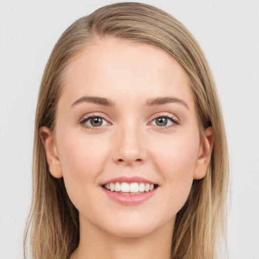 Joyful white young-adult female with long  brown hair and grey eyes