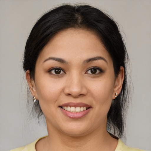 Joyful asian young-adult female with medium  brown hair and brown eyes