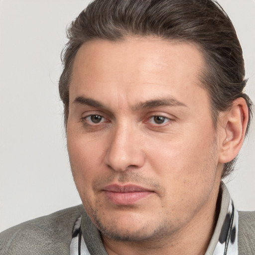 Joyful white adult male with short  brown hair and brown eyes