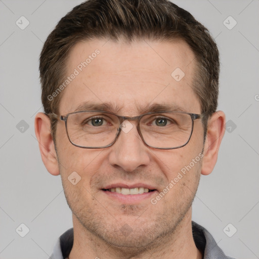 Joyful white adult male with short  brown hair and grey eyes