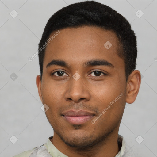 Joyful black young-adult male with short  black hair and brown eyes