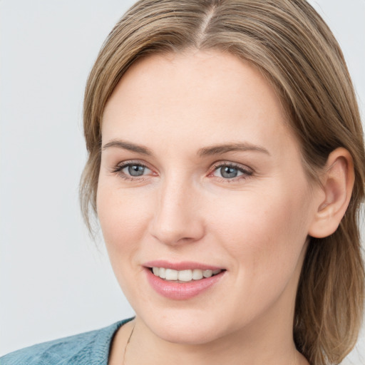 Joyful white young-adult female with medium  brown hair and blue eyes