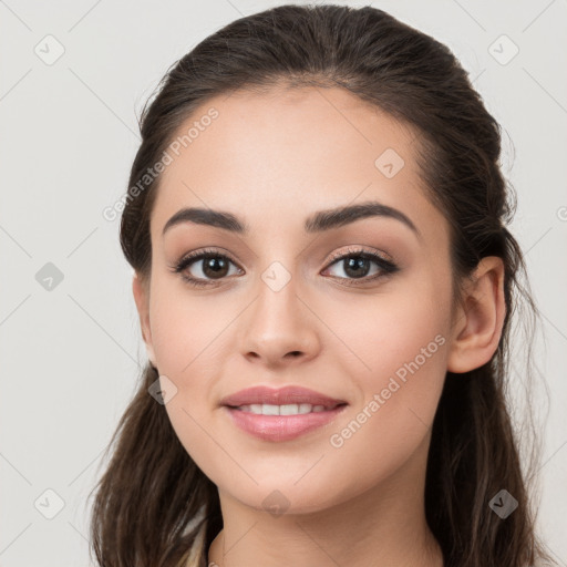 Joyful white young-adult female with long  brown hair and brown eyes