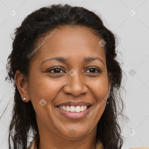 Joyful black adult female with long  brown hair and brown eyes