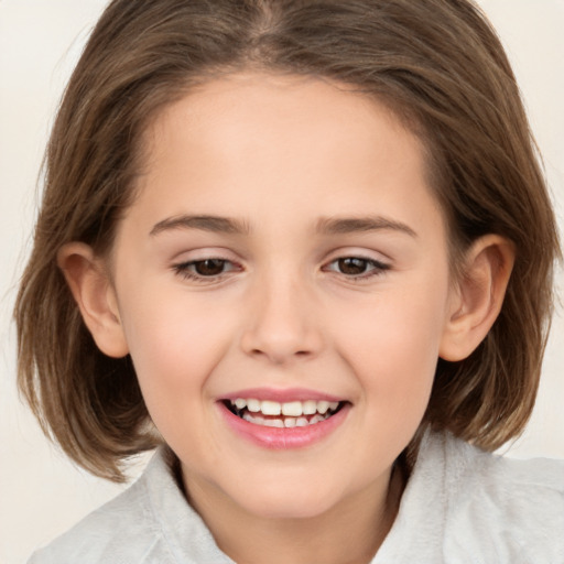 Joyful white child female with medium  brown hair and brown eyes