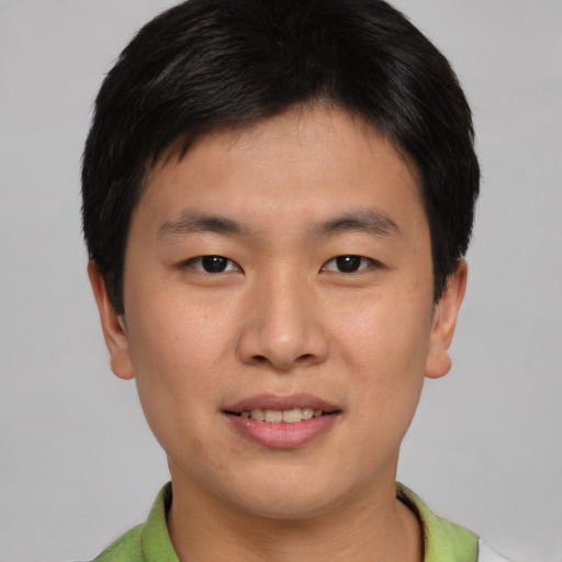 Joyful asian young-adult male with short  brown hair and brown eyes