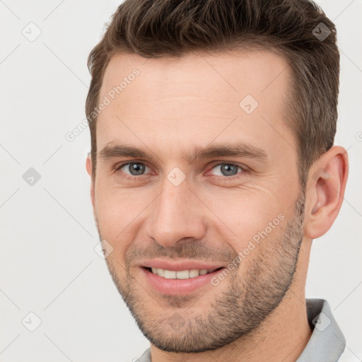 Joyful white young-adult male with short  brown hair and brown eyes