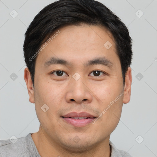 Joyful asian young-adult male with short  brown hair and brown eyes