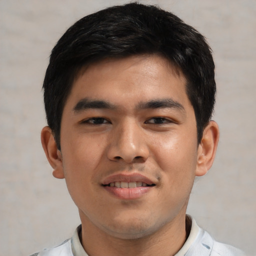 Joyful asian young-adult male with short  brown hair and brown eyes
