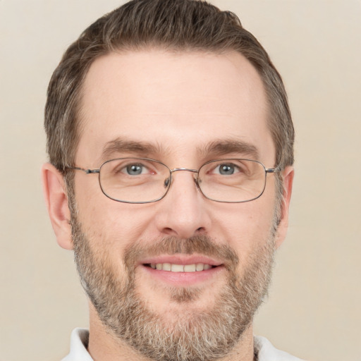 Joyful white adult male with short  brown hair and brown eyes