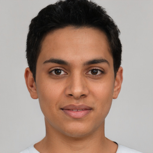 Joyful latino young-adult male with short  black hair and brown eyes