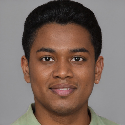 Joyful black young-adult male with short  black hair and brown eyes