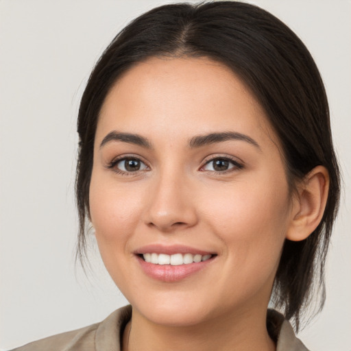 Joyful white young-adult female with medium  brown hair and brown eyes