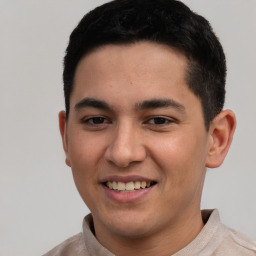 Joyful white young-adult male with short  black hair and brown eyes