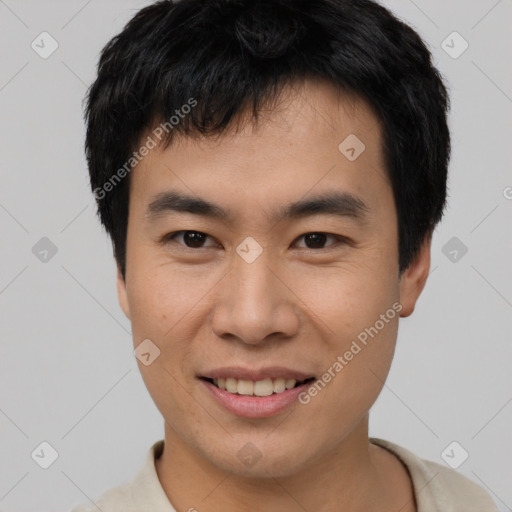 Joyful asian young-adult male with short  black hair and brown eyes