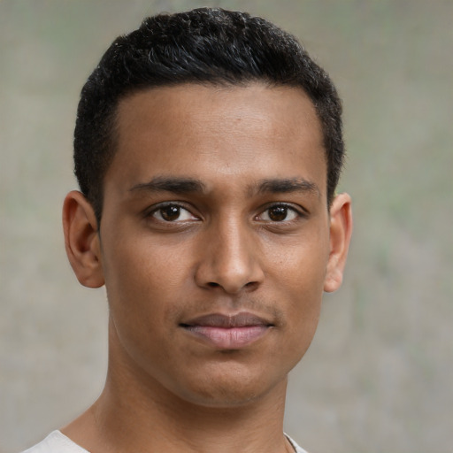 Joyful black young-adult male with short  brown hair and brown eyes