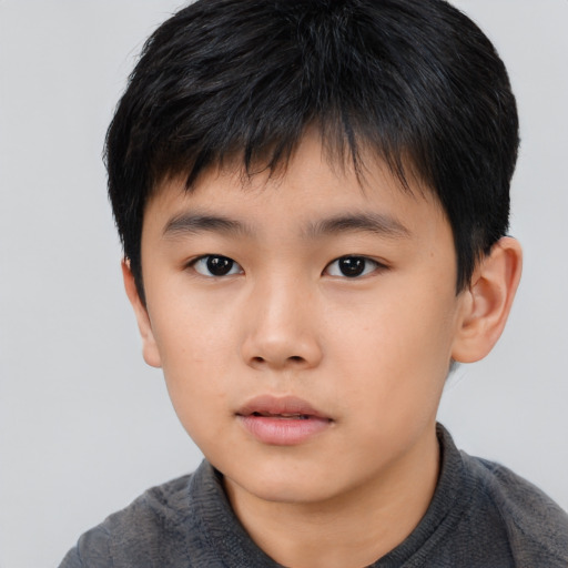 Neutral asian child male with short  brown hair and brown eyes