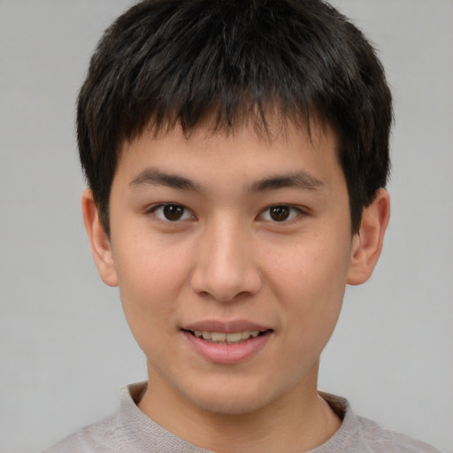 Joyful asian child male with short  brown hair and brown eyes
