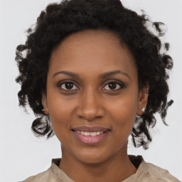 Joyful black young-adult female with medium  brown hair and brown eyes