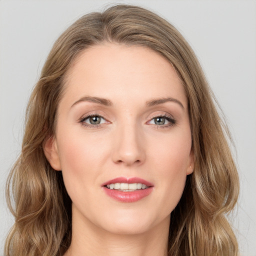 Joyful white young-adult female with long  brown hair and grey eyes