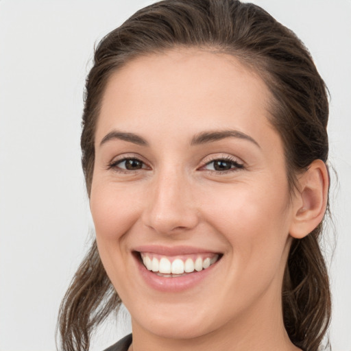 Joyful white young-adult female with medium  brown hair and brown eyes