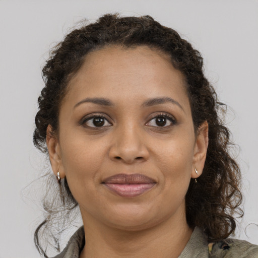 Joyful black young-adult female with medium  brown hair and brown eyes