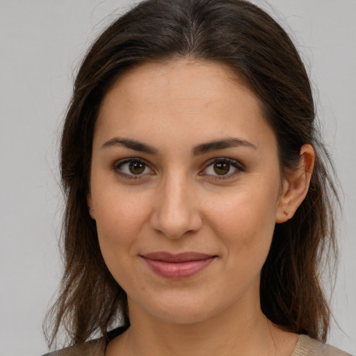 Joyful white young-adult female with medium  brown hair and brown eyes