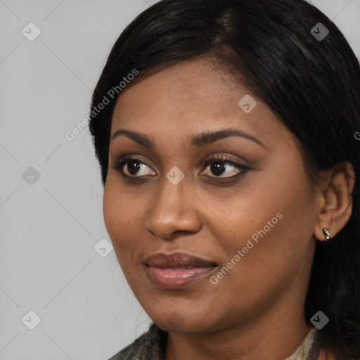 Joyful black young-adult female with long  black hair and brown eyes