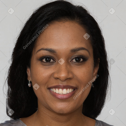 Joyful black young-adult female with long  brown hair and brown eyes