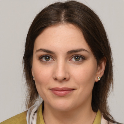 Joyful white young-adult female with medium  brown hair and brown eyes