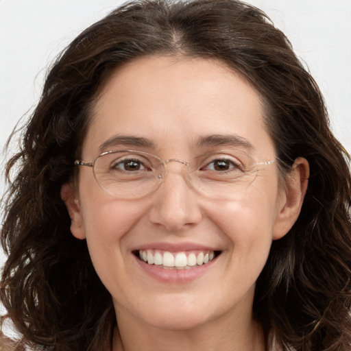 Joyful white adult female with long  brown hair and brown eyes