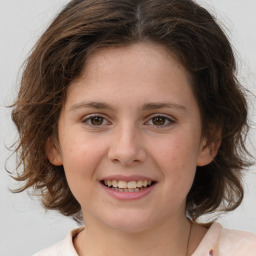 Joyful white child female with medium  brown hair and brown eyes