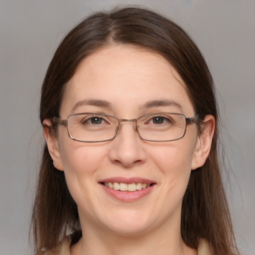 Joyful white adult female with medium  brown hair and grey eyes