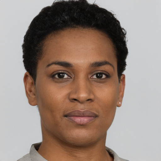 Joyful black young-adult female with short  brown hair and brown eyes