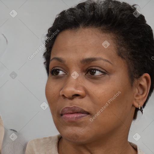 Joyful black young-adult female with short  brown hair and brown eyes