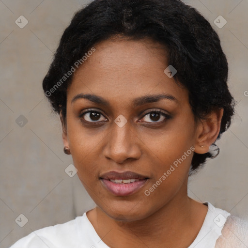 Joyful black young-adult female with short  black hair and brown eyes