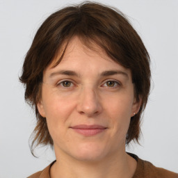 Joyful white adult female with medium  brown hair and brown eyes