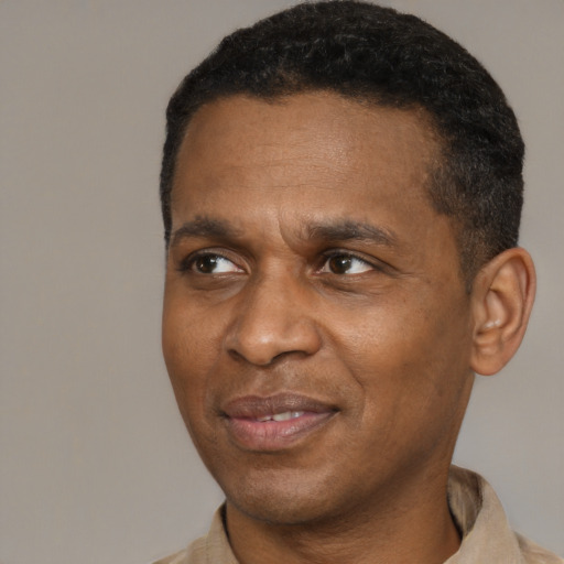 Joyful latino adult male with short  brown hair and brown eyes