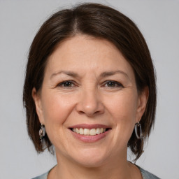 Joyful white adult female with medium  brown hair and brown eyes