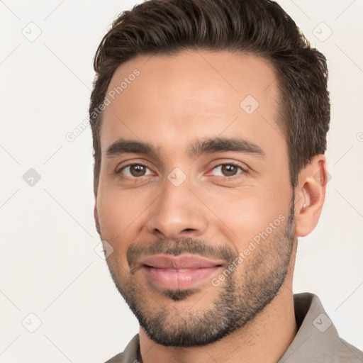 Joyful white young-adult male with short  black hair and brown eyes