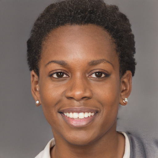 Joyful black young-adult female with short  brown hair and brown eyes