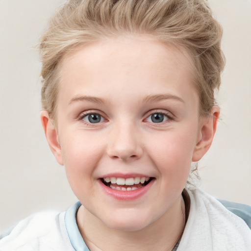 Joyful white child female with short  brown hair and blue eyes