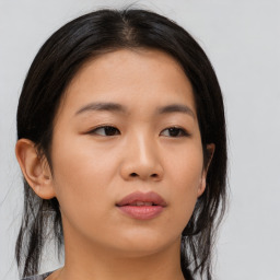 Joyful asian young-adult female with medium  black hair and brown eyes