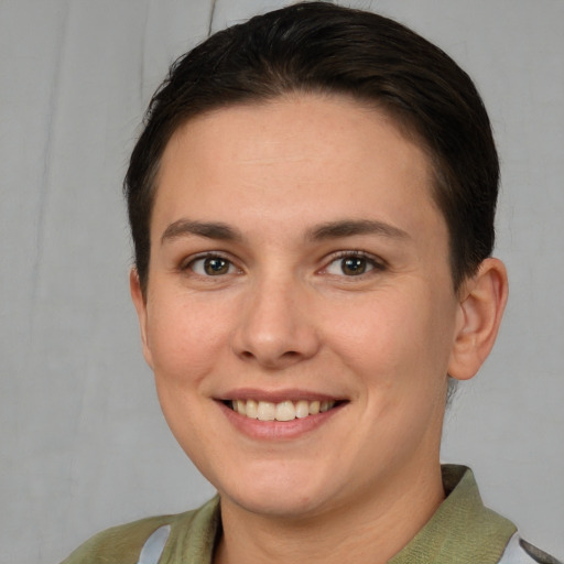 Joyful white young-adult female with short  brown hair and brown eyes