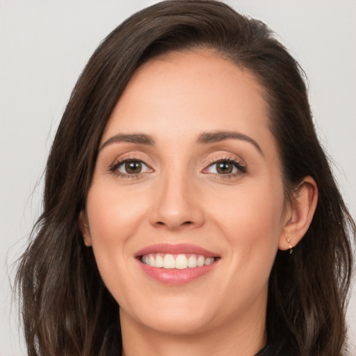 Joyful white young-adult female with long  brown hair and brown eyes