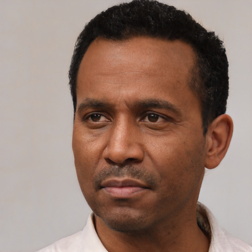 Neutral latino adult male with short  black hair and brown eyes